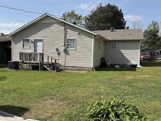 rear view of property with crawl space, a yard, and central air condition unit