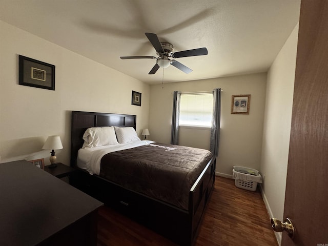 bedroom featuring ceiling fan, baseboards, and dark wood finished floors