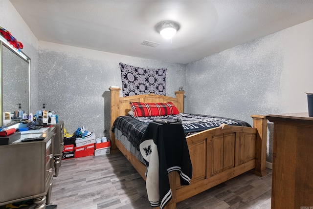 580 Providence Loop, Malvern, AR 72104 - bedroom featuring a textured wall, light wood-style floors, and visible vents