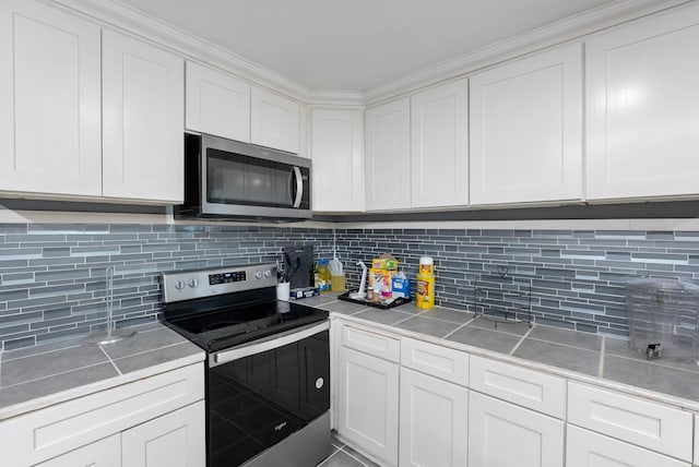 580 Providence Loop, Malvern, AR 72104 - kitchen featuring white cabinets, tasteful backsplash, light countertops, and appliances with stainless steel finishes