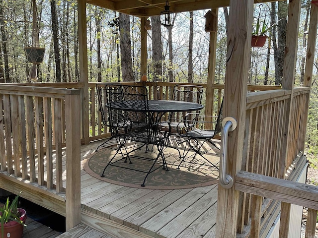 wooden deck featuring outdoor dining area