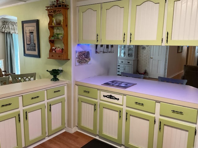 kitchen with tasteful backsplash, light countertops, a peninsula, and dark wood finished floors