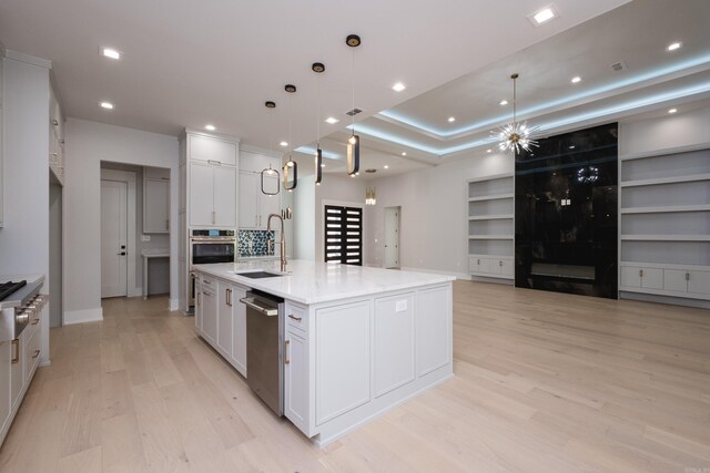 221 Abington Cir, Little Rock, AR 72223 - kitchen with white cabinets, light wood-style flooring, a sink, and appliances with stainless steel finishes