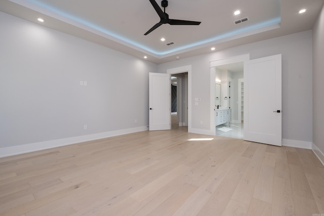 221 Abington Cir, Little Rock, AR 72223 - unfurnished bedroom with visible vents, light wood-type flooring, a tray ceiling, and recessed lighting