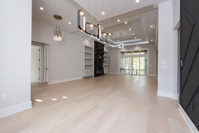 221 Abington Cir, Little Rock, AR 72223 - unfurnished room featuring baseboards, a raised ceiling, and light wood finished floors