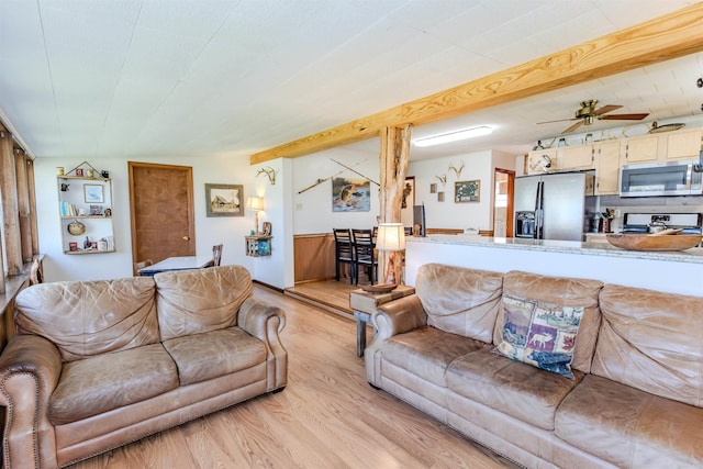 living area featuring light wood-style floors and a ceiling fan