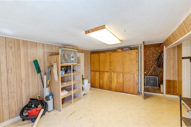 finished basement featuring wood walls and visible vents