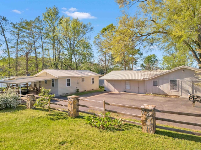 back of house featuring a yard, metal roof, crawl space, and a fenced front yard