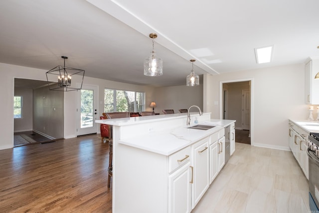 104 Dickson Dr, Little Rock, AR 72207 - kitchen with open floor plan, a healthy amount of sunlight, a sink, and light countertops