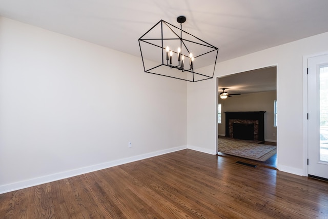 104 Dickson Dr, Little Rock, AR 72207 - unfurnished dining area featuring a notable chandelier, dark wood-style flooring, baseboards, and visible vents