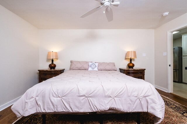 104 Dickson Dr, Little Rock, AR 72207 - bedroom featuring baseboards, freestanding refrigerator, a ceiling fan, and wood finished floors