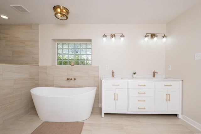 104 Dickson Dr, Little Rock, AR 72207 - full bathroom with a sink, visible vents, double vanity, and a soaking tub