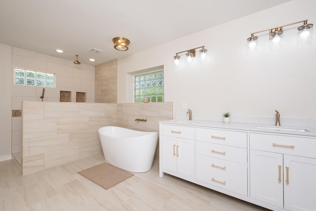 104 Dickson Dr, Little Rock, AR 72207 - bathroom featuring a sink, visible vents, a walk in shower, and a soaking tub