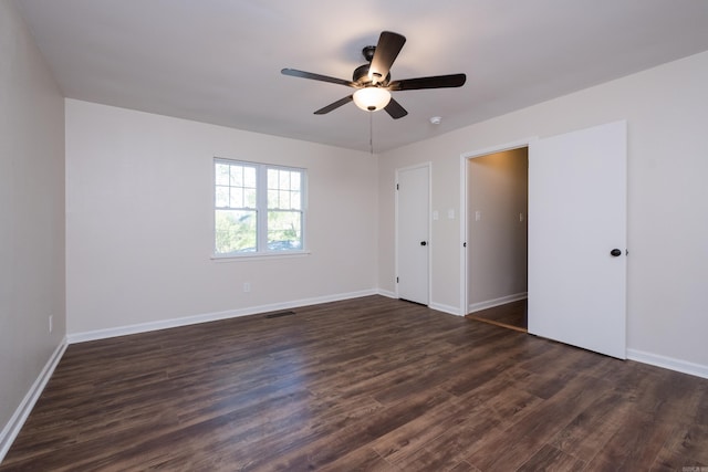 104 Dickson Dr, Little Rock, AR 72207 - unfurnished bedroom with dark wood-style floors, baseboards, visible vents, and a ceiling fan