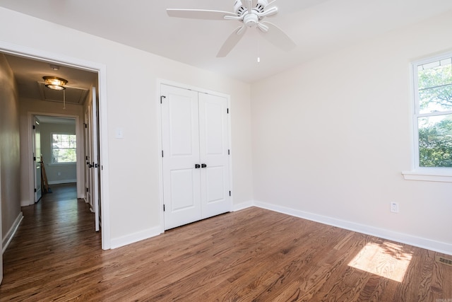104 Dickson Dr, Little Rock, AR 72207 - unfurnished bedroom featuring wood finished floors, attic access, baseboards, and multiple windows
