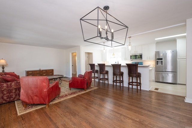 104 Dickson Dr, Little Rock, AR 72207 - living area featuring a chandelier and wood finished floors