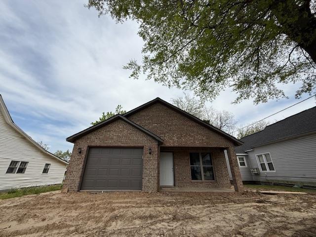 615 N Pruett, Paragould, AR 72450 - view of front facade with brick siding and a garage
