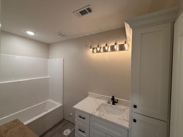 615 N Pruett, Paragould, AR 72450 - full bathroom with vanity, visible vents, and wood finished floors