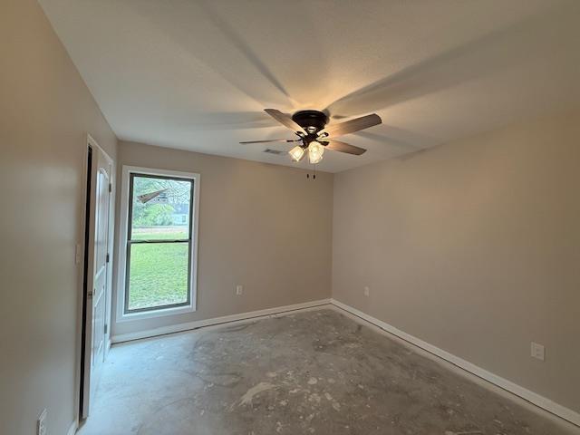 615 N Pruett, Paragould, AR 72450 - unfurnished room with concrete flooring, baseboards, and a ceiling fan