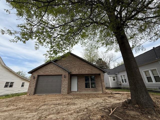 615 N Pruett, Paragould, AR 72450 - exterior space featuring an attached garage and brick siding