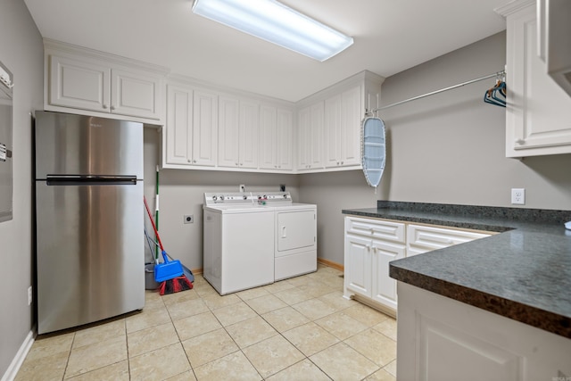 166 Heatherwood, Hot Springs, AR 71913 - clothes washing area with light tile patterned floors, baseboards, washing machine and clothes dryer, and cabinet space