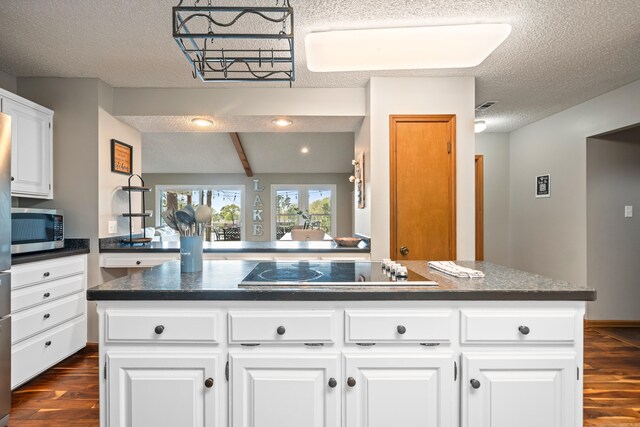 166 Heatherwood, Hot Springs, AR 71913 - kitchen featuring stainless steel microwave, a textured ceiling, black electric stovetop, and dark wood finished floors