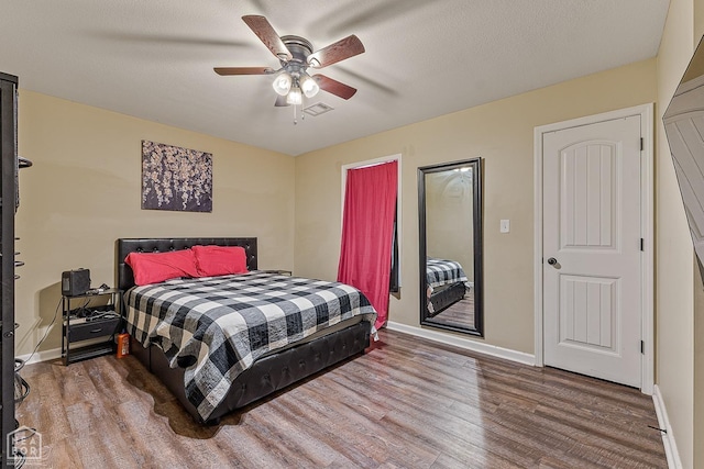 1104 Cartwright, Jonesboro, AR 72401 - bedroom with visible vents, baseboards, a ceiling fan, and wood finished floors