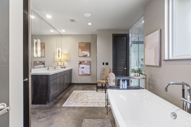 full bathroom with a soaking tub, recessed lighting, visible vents, finished concrete floors, and a sink