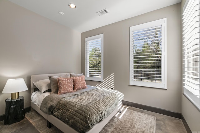 bedroom with recessed lighting, concrete floors, visible vents, and baseboards