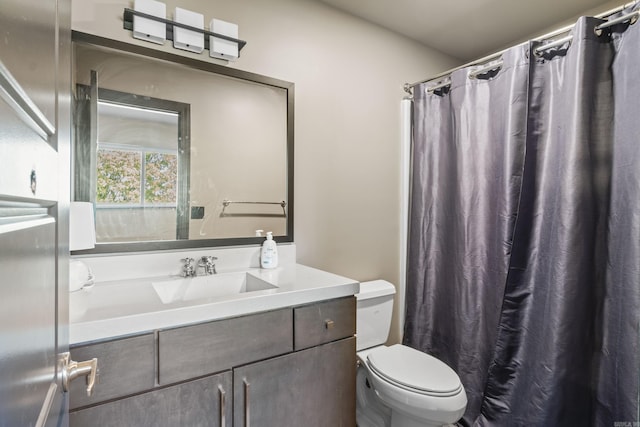 full bath featuring curtained shower, vanity, and toilet