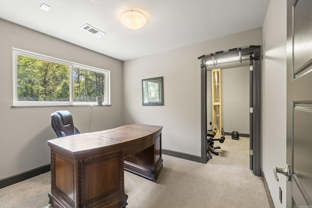 carpeted office with visible vents and baseboards