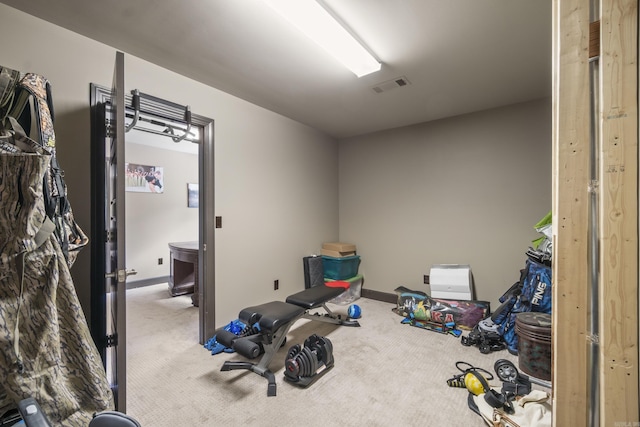 workout room featuring visible vents, baseboards, and carpet floors
