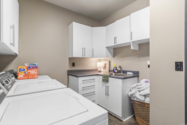 laundry room featuring washer and clothes dryer, a sink, and cabinet space