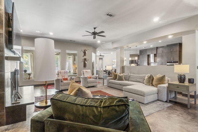 living area with concrete floors, visible vents, a ceiling fan, and recessed lighting