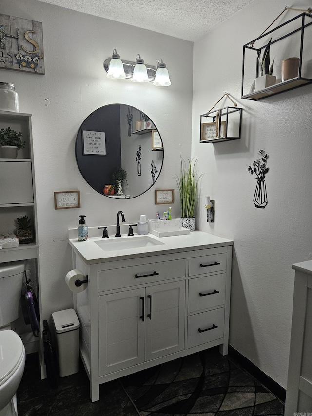 1139 Crescent Dr, Mena, AR 71953 - bathroom featuring toilet, vanity, and a textured ceiling