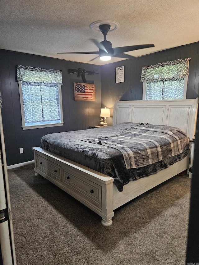 1139 Crescent Dr, Mena, AR 71953 - bedroom featuring a textured ceiling, wood walls, ceiling fan, and carpet floors