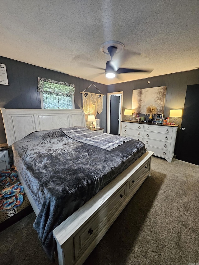 1139 Crescent Dr, Mena, AR 71953 - carpeted bedroom featuring a textured ceiling, wood walls, and ceiling fan
