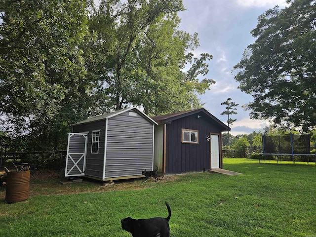 1139 Crescent Dr, Mena, AR 71953 - view of shed with fence and a trampoline