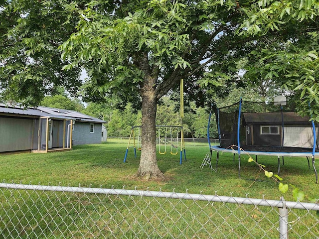 1139 Crescent Dr, Mena, AR 71953 - view of yard featuring a trampoline, fence, and a playground
