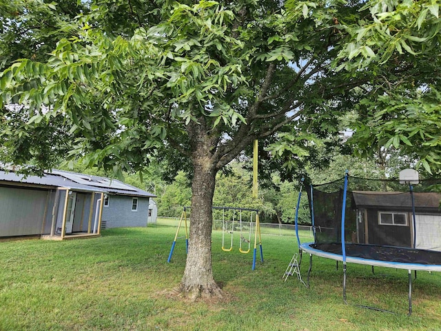 1139 Crescent Dr, Mena, AR 71953 - view of yard featuring fence, a trampoline, and a playground