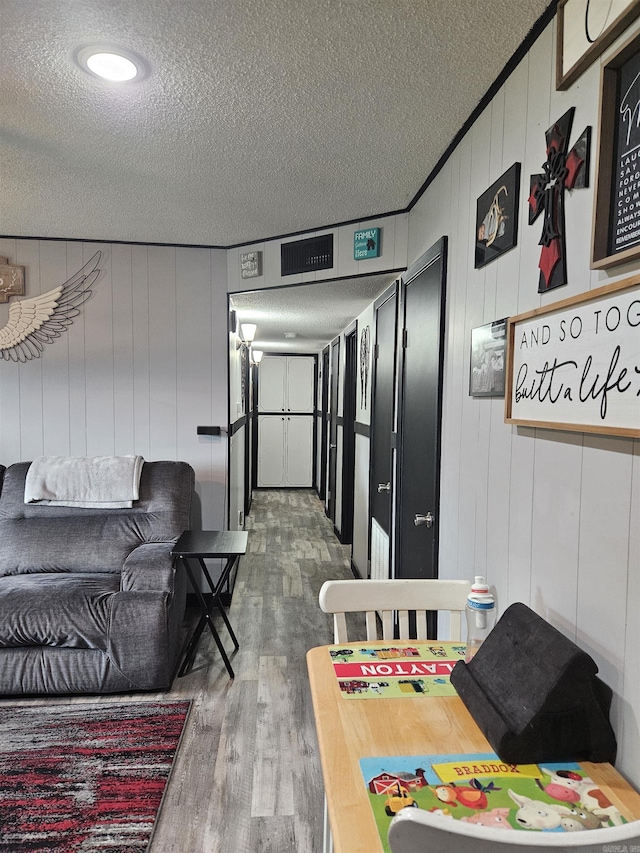 1139 Crescent Dr, Mena, AR 71953 - interior space with a textured ceiling and wood finished floors