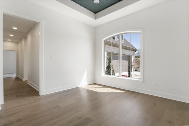 unfurnished room featuring baseboards, recessed lighting, and wood finished floors