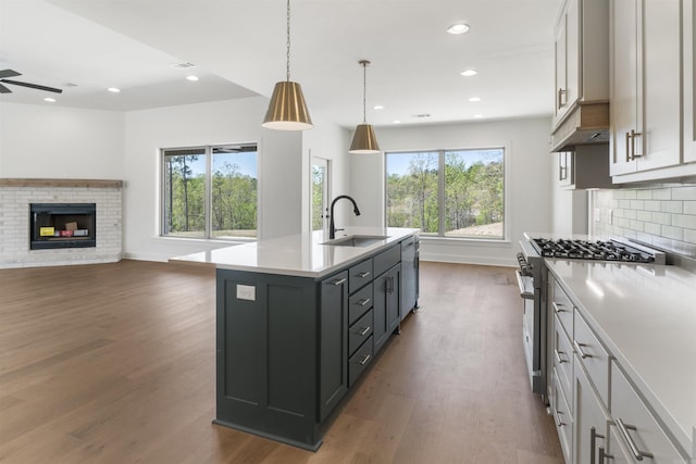 kitchen with plenty of natural light, light countertops, a sink, and appliances with stainless steel finishes
