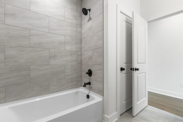 full bath with baseboards and shower / bathing tub combination