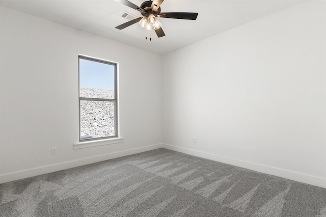carpeted empty room with baseboards and a ceiling fan