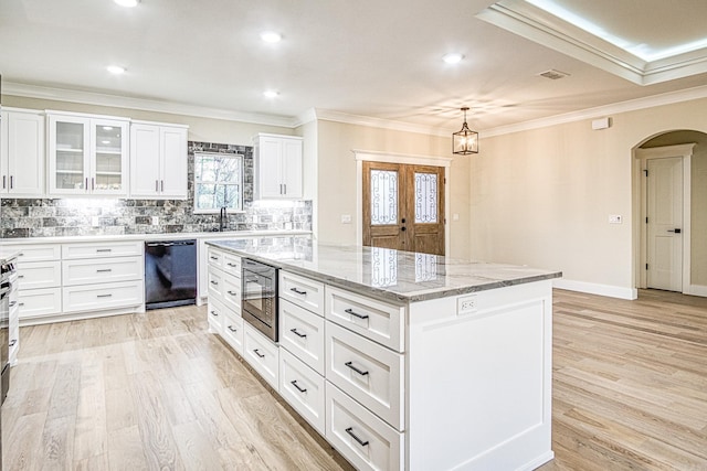 7 San Pablo Ln, Hot Springs Village, AR 71909 - kitchen with crown molding, a kitchen island, light stone countertops, arched walkways, and black appliances