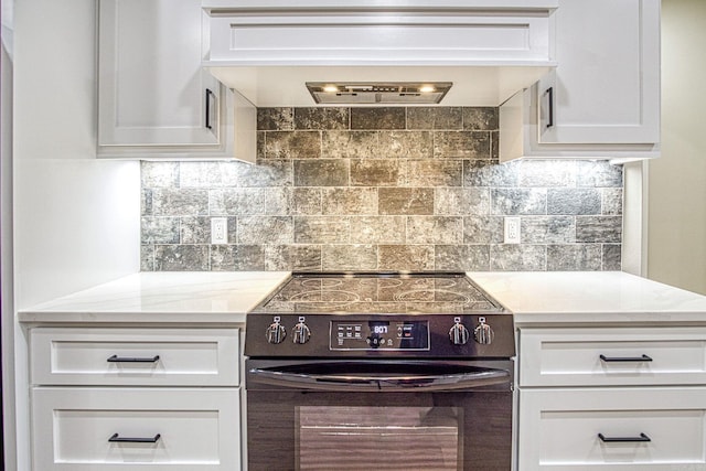 7 San Pablo Ln, Hot Springs Village, AR 71909 - kitchen featuring premium range hood, white cabinets, tasteful backsplash, and black range with electric cooktop