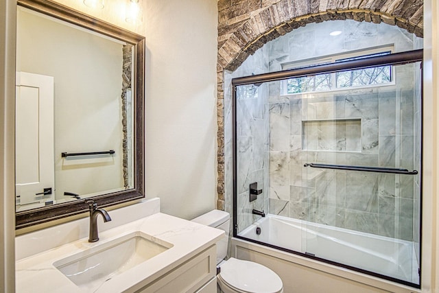 7 San Pablo Ln, Hot Springs Village, AR 71909 - bathroom featuring toilet, vanity, and bath / shower combo with glass door