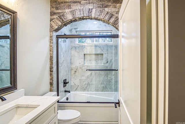 7 San Pablo Ln, Hot Springs Village, AR 71909 - bathroom featuring toilet, vanity, and bath / shower combo with glass door