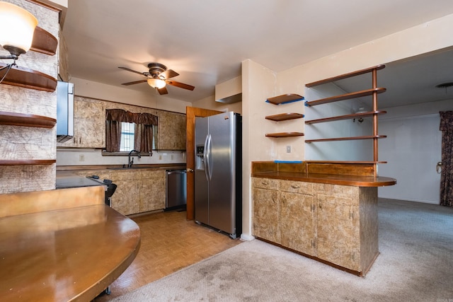 kitchen featuring dark countertops, a ceiling fan, open shelves, and appliances with stainless steel finishes
